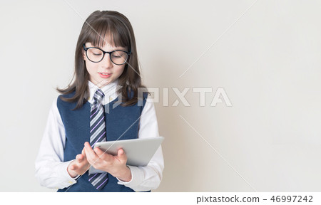 Girl looking at a tablet Girl looking at a tablet 46997242