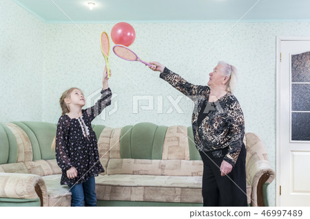 grandmother plays with the granddaughter of balloon 46997489