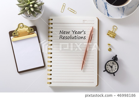 New year resolutions in notebook on white desk 46998186