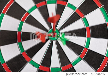 Three Darts hit red target on the target right close-up Three Darts hit red target on the target right close-up 46998797
