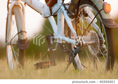 detail of bicycle closeup on grass field 46998861