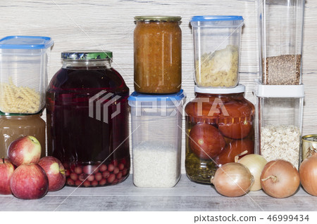 Storage shelves in pantry with homemade canned preserved fruits and vegetables 46999434
