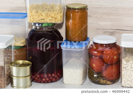 Storage shelves in pantry with homemade canned preserved fruits and vegetables Storage shelves in pantry with homemade canned preserved fruits and vegetables 46999442