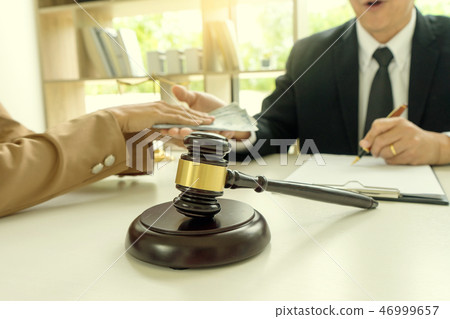Judge lawyer gavel with bribe money in law firm 46999657