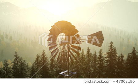 Typical Old Windmill turbine in forest at sunset 47002190