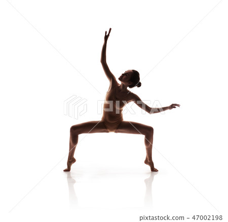 young beautiful dancer in beige swimsuit posing young beautiful dancer in beige swimsuit posing 47002198