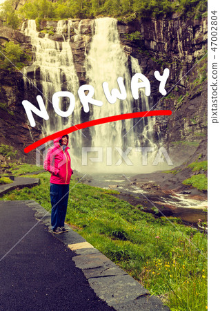 Tourist woman by Skjervsfossen Waterfall - Norway Tourist woman by Skjervsfossen Waterfall - Norway 47002804