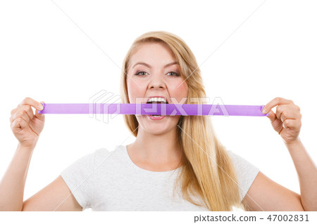 Attractive blonde woman biting tape on mouth. Attractive blonde woman biting tape on mouth. 47002831