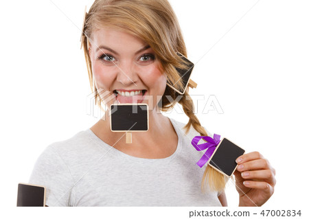 Teenage girl biting little school blackboards 47002834
