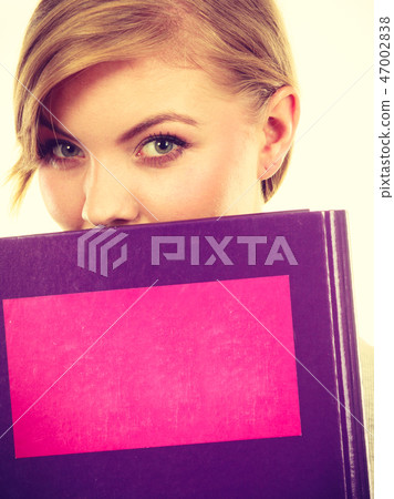 Young teenage student with braid holding books 47002838