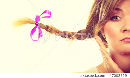 Sad teenage girl in windblown braid hair 47002839