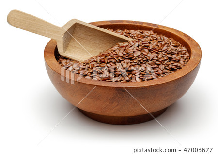Flax seeds in wooden bowl Flax seeds in wooden bowl 47003677