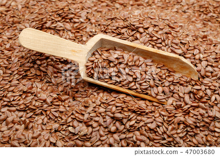 Flax seeds in wooden scoop Flax seeds in wooden scoop 47003680