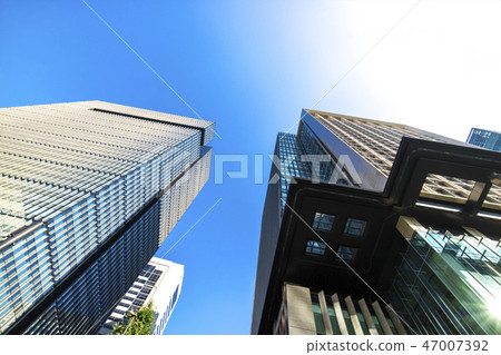 Landscape of the office town looking up at a skyscraper Landscape of the office town looking up at a skyscraper 47007392
