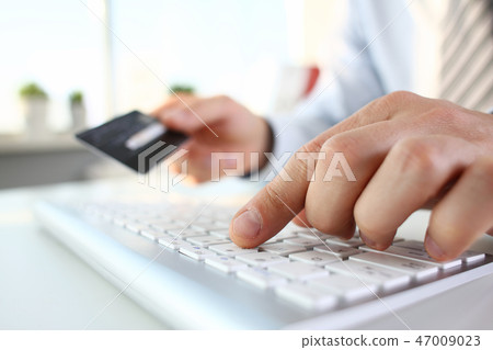 Male arms hold credit card press buttons Male arms hold credit card press buttons 47009023
