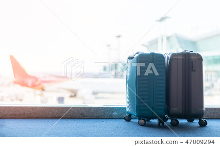 Travel luggage suitcase at the airport terminal  47009294