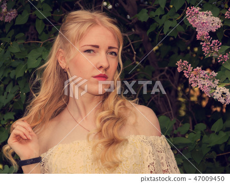 Portrait of a sad girl with blond hair. 47009450