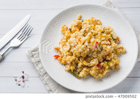 Pilaf with vegetables and chicken in a gray plate  47009502