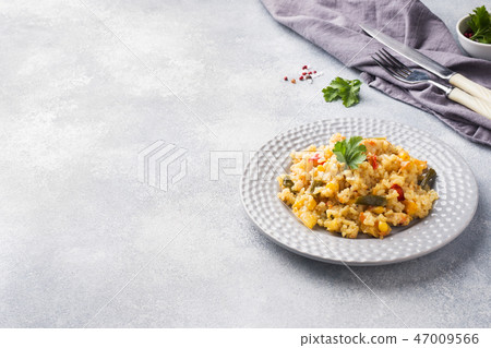 Pilaf with vegetables and chicken in a gray plate Pilaf with vegetables and chicken in a gray plate 47009566