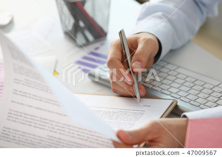 Hand of businessman in suit filling and Hand of businessman in suit filling and 47009567