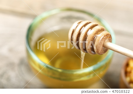honey in a plate with a spoon for honey honey in a plate with a spoon for honey 47010322