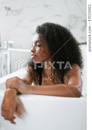 Young brown skin girl lying in barth and wearing black underwear. Young brown skin girl lying in barth and wearing black underwear. 47010901