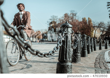 Positive delighted male person enjoying autumn weather Positive delighted male person enjoying autumn weather 47010930