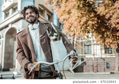 Cheerful bearded man keeping smile on his face 47010943