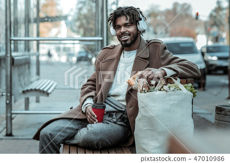 Cheerful international male having rest after walk Cheerful international male having rest after walk 47010986