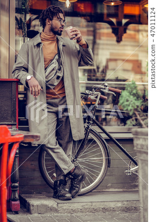 Handsome brunette man enjoying tasty hot cacao Handsome brunette man enjoying tasty hot cacao 47011124
