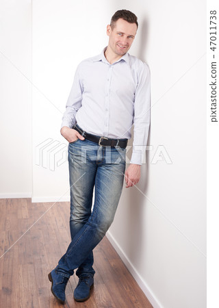 Positive smiling young man 47011738