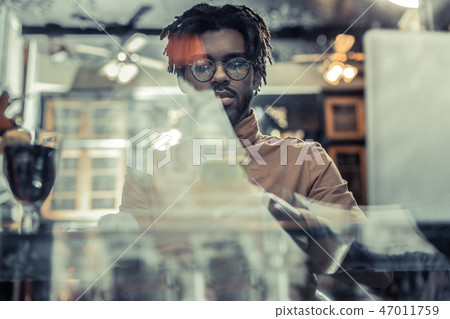Handsome brunette man looking at glass of wine Handsome brunette man looking at glass of wine 47011759