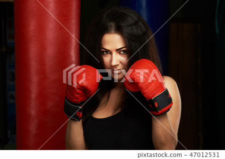 Woman boxer in red gloves Woman boxer in red gloves 47012531