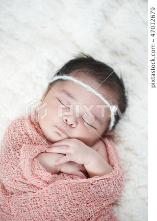 Newborn sleeping above top view 47012679