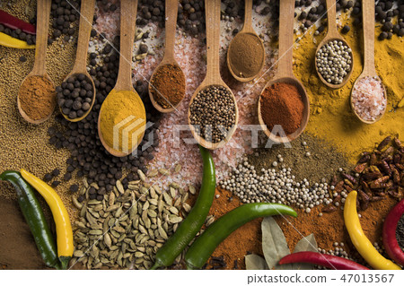 Assortment of spices in wooden bowl background Assortment of spices in wooden bowl background 47013567