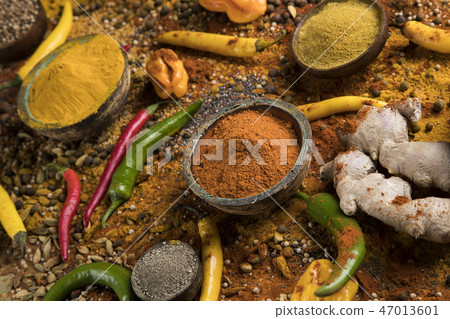 Variety of spices and herbs on kitchen table Variety of spices and herbs on kitchen table 47013601