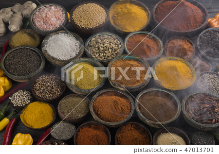 Variety of spices and herbs on kitchen table Variety of spices and herbs on kitchen table 47013701