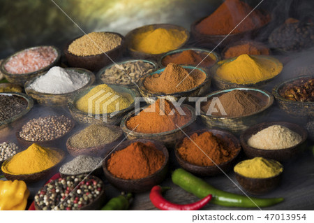 Variety of spices and herbs on kitchen table 47013954