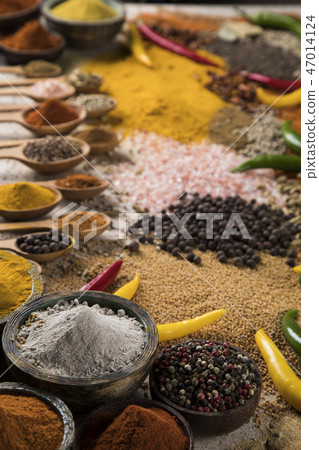 Assortment of spices in wooden bowl background 47014124