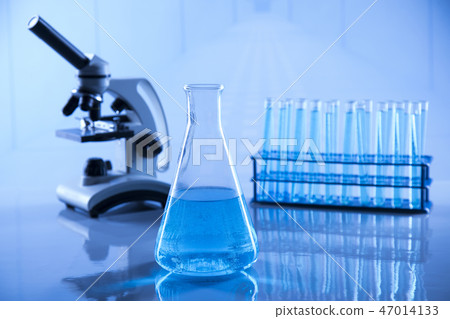 Laboratory beakers, microscope, blue background 47014133