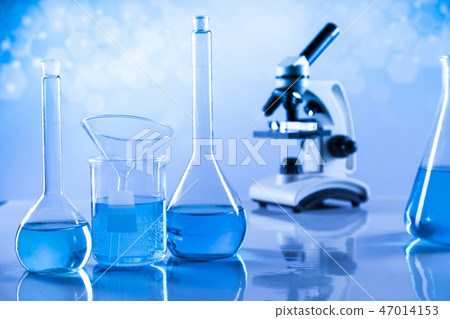 Laboratory beakers, microscope, blue background 47014153