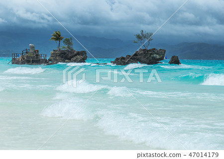 Island Grotto at turquoise azure Sea on a cloudy day. Boracay, Philippines Island Grotto at turquoise azure Sea on a cloudy day. Boracay, Philippines 47014179