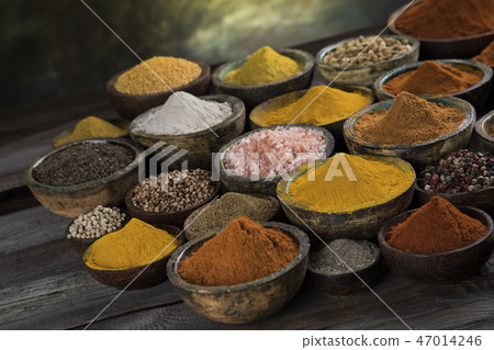 Assortment of spices in wooden bowl background 47014246