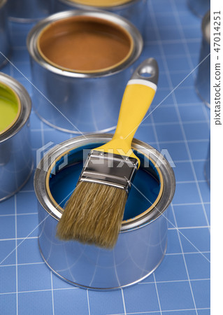 Open cans of paint,Brush, blue background 47014251