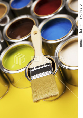 Tin cans with paint and brushes, yellow background 47014512