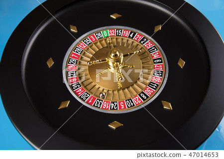 Gaming table, roulette wheel in motion 47014653