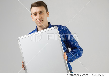 Entrepreneur with a magnetic Board in his hands on white background 47015026