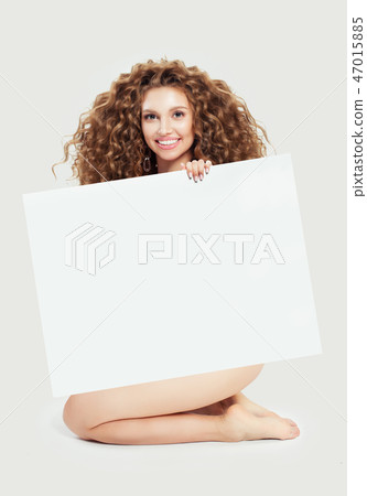 Beautiful young blonde woman holding big empty  47015885
