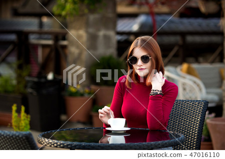 Lifestyle fashion portrait of young stylish hipster woman walking on the street. 47016110