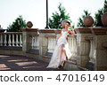fashion photo of beautiful woman in wedding dress posing outdoor. 47016149